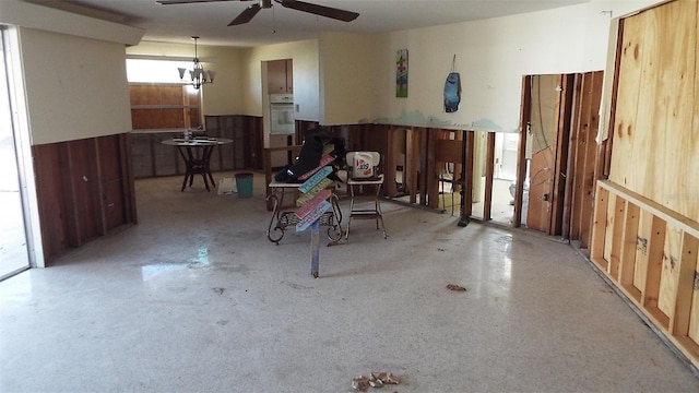 misc room with wood walls and ceiling fan