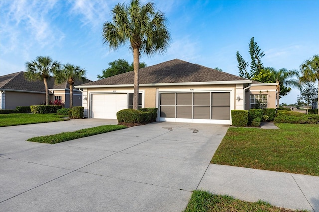 ranch-style home featuring a garage and a front lawn