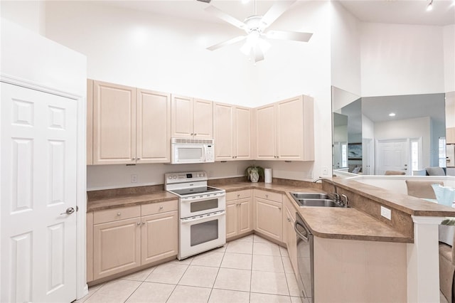 kitchen with sink, high vaulted ceiling, kitchen peninsula, white appliances, and light tile patterned flooring