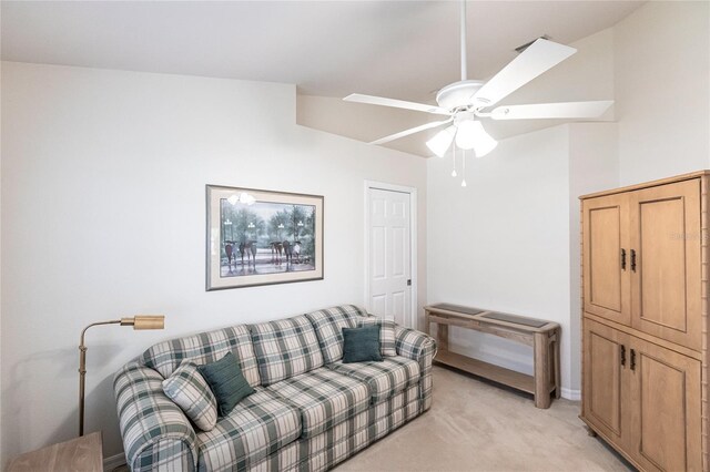 living room with light colored carpet, ceiling fan, and lofted ceiling