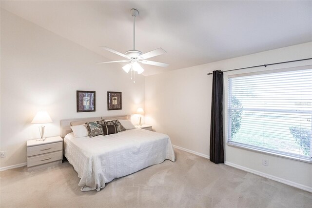 bedroom with light colored carpet and ceiling fan