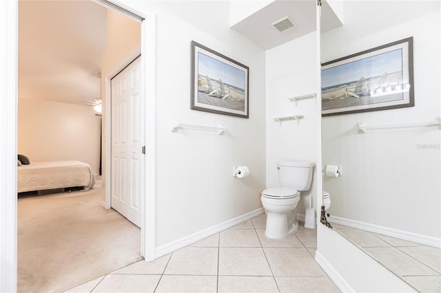 bathroom featuring tile patterned flooring, toilet, and ceiling fan