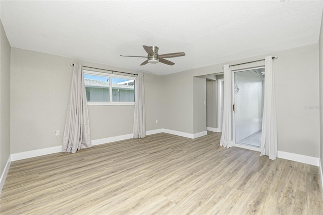 empty room featuring light wood-type flooring and ceiling fan