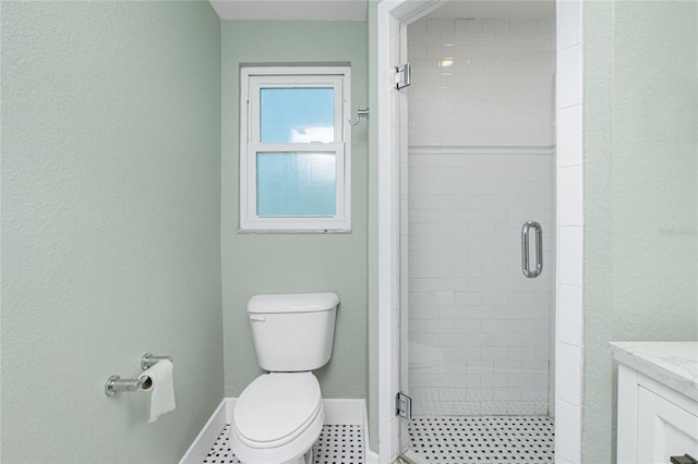 bathroom featuring vanity, toilet, and walk in shower