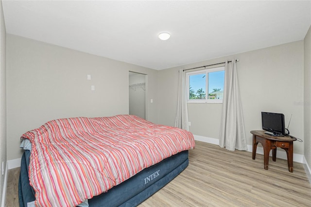 bedroom featuring a closet and light hardwood / wood-style flooring