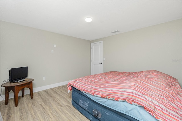 bedroom with light hardwood / wood-style flooring