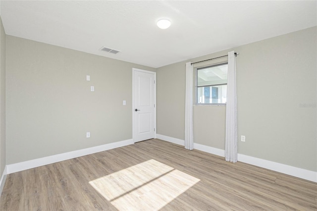 spare room featuring light hardwood / wood-style floors