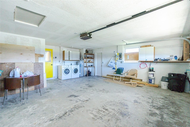 garage featuring a garage door opener and washing machine and clothes dryer