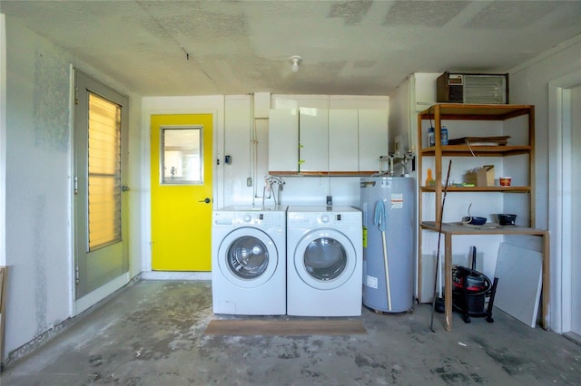 washroom featuring electric water heater, washer and dryer, and a textured ceiling