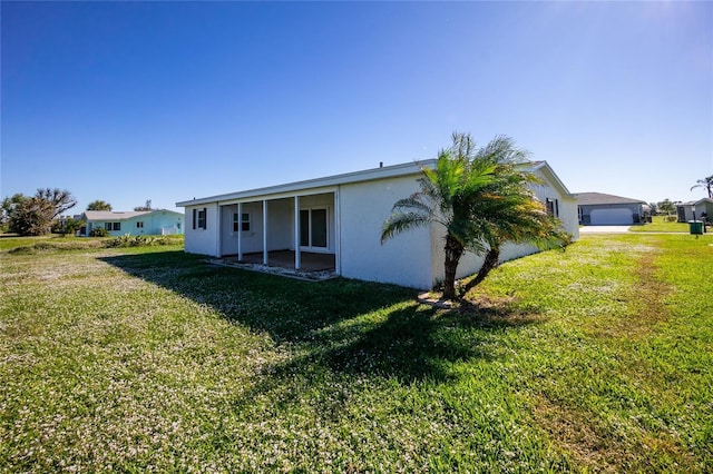 rear view of property with a yard