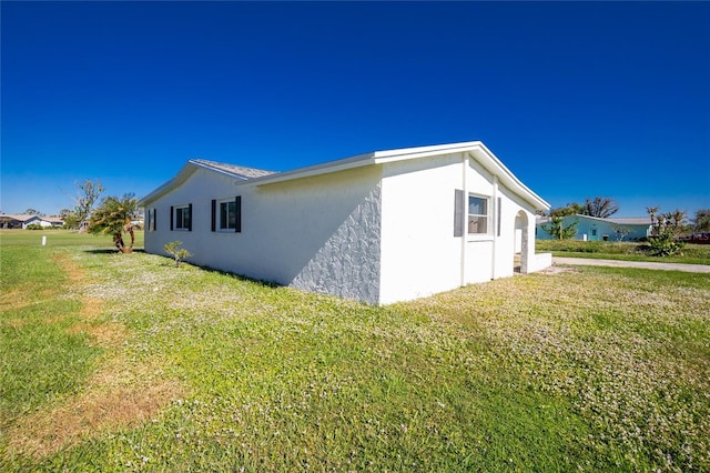 view of side of home featuring a lawn