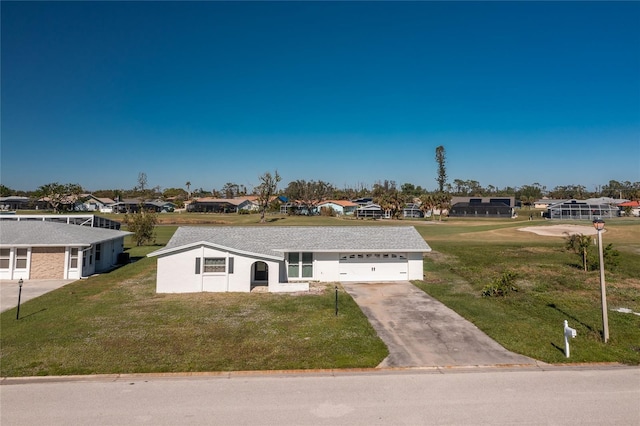 ranch-style house featuring a garage and a front lawn