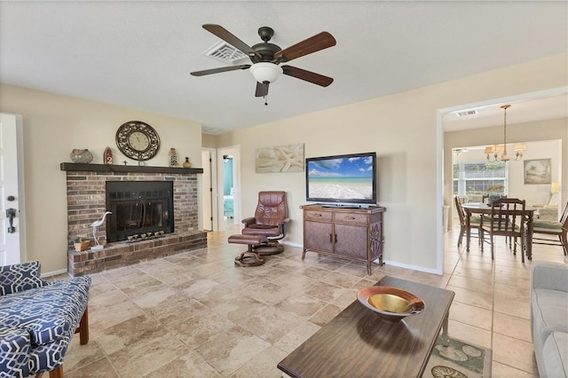 living room with ceiling fan with notable chandelier and a fireplace