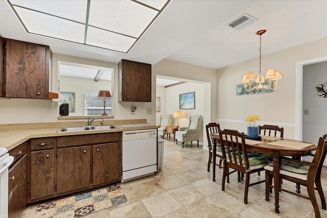 kitchen featuring dark brown cabinets, white appliances, sink, an inviting chandelier, and hanging light fixtures