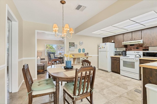 dining space with a chandelier