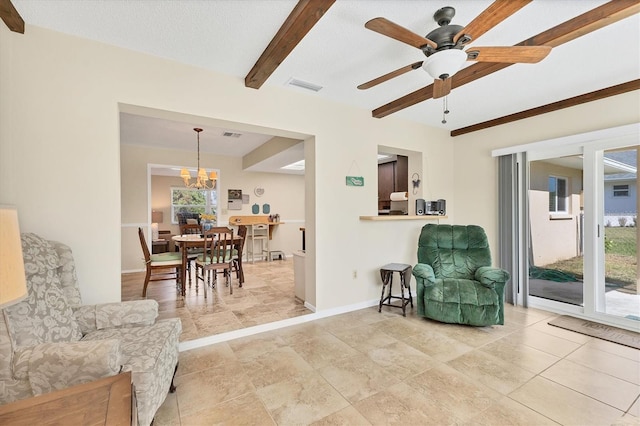 sitting room with beamed ceiling and ceiling fan with notable chandelier