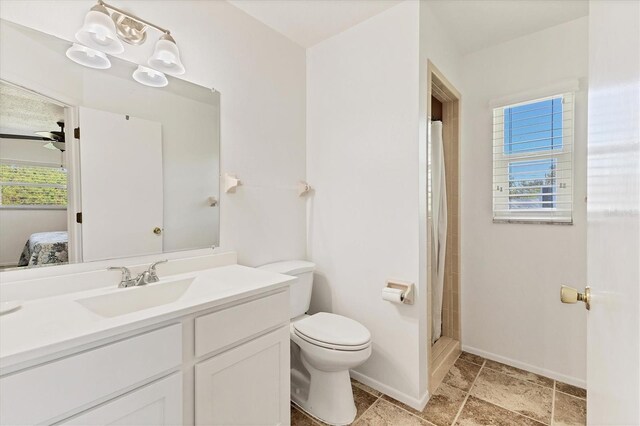 bathroom with vanity, toilet, and a shower with door