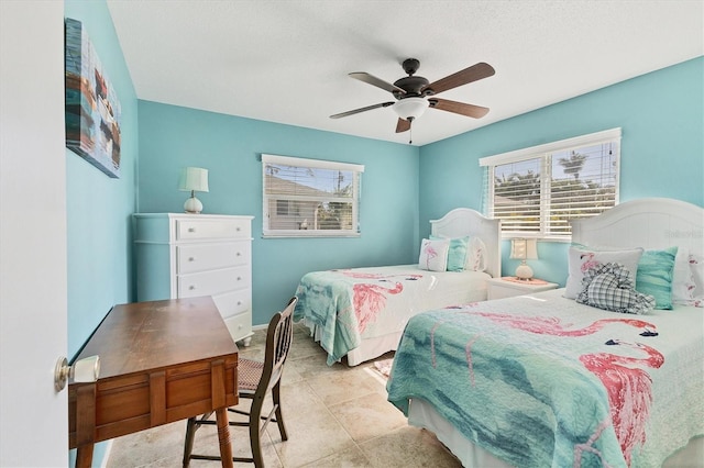 bedroom with ceiling fan and light tile patterned floors