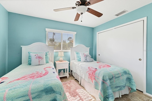 bedroom with ceiling fan and a closet