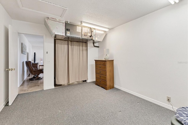 bedroom featuring a textured ceiling and carpet floors