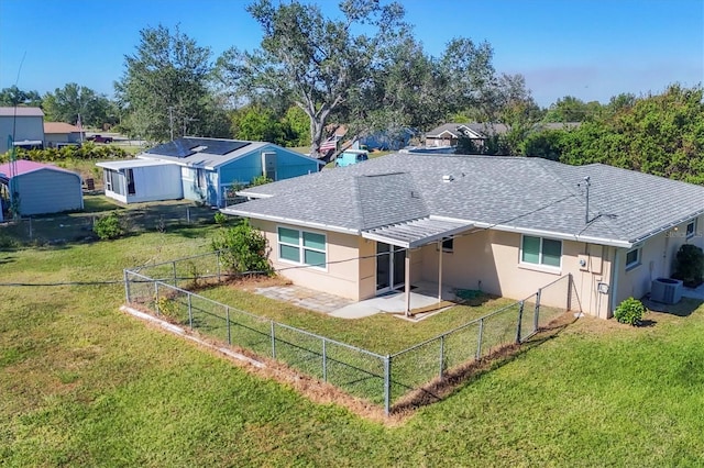 back of house with a yard, central AC, and a patio area