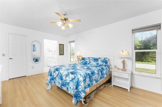 bedroom featuring a textured ceiling, wood finished floors, and a ceiling fan