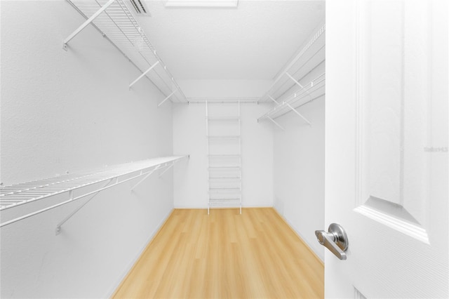 walk in closet featuring wood finished floors