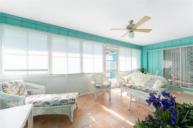 living room featuring light tile patterned floors and a ceiling fan