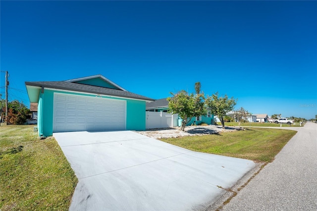 view of front of property with a garage, a front lawn, and stucco siding