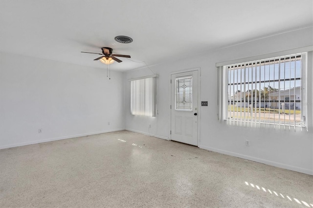 foyer entrance featuring ceiling fan