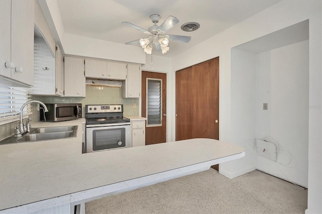 kitchen featuring decorative backsplash, appliances with stainless steel finishes, ceiling fan, sink, and range hood