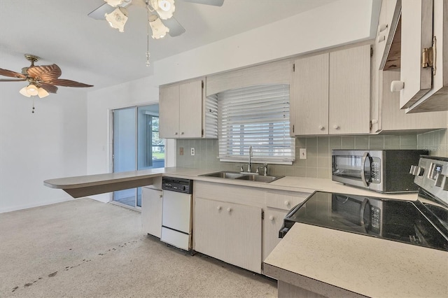 kitchen with appliances with stainless steel finishes, backsplash, ceiling fan, and sink