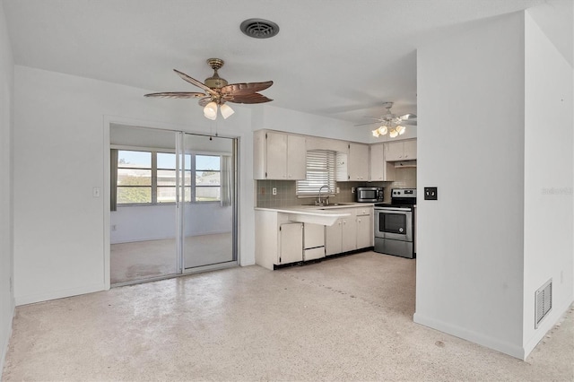 kitchen with white cabinetry, sink, ceiling fan, tasteful backsplash, and stainless steel electric range