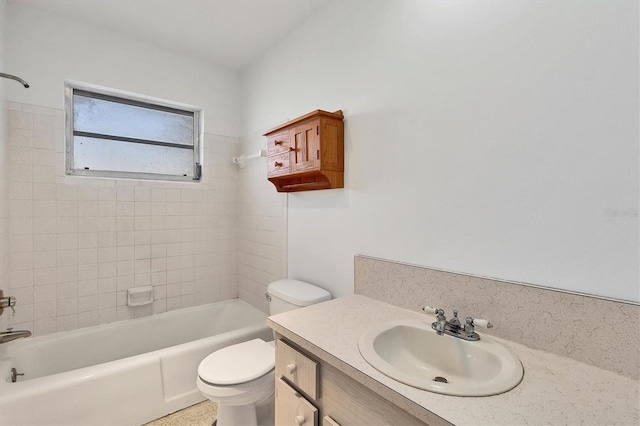 full bathroom with vanity, tiled shower / bath combo, and toilet