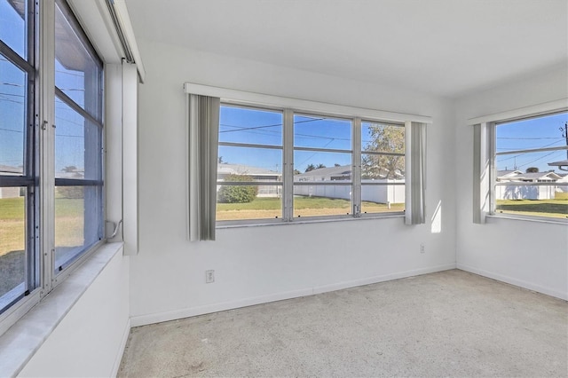 unfurnished room featuring a wealth of natural light