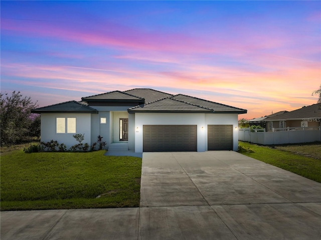14681 Keystone Blvd, Port Charlotte, FL 33981 - view of front of house with an attached garage, concrete driveway, a tiled roof, and stucco siding