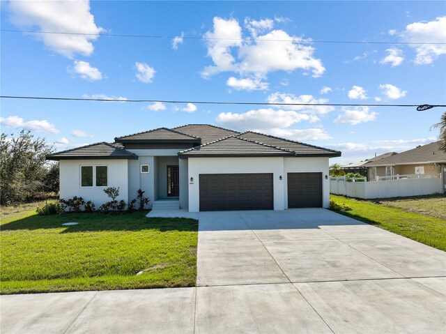 14681 Keystone Blvd, Port Charlotte, FL 33981 - prairie-style home featuring driveway, a garage, stucco siding, and a tiled roof