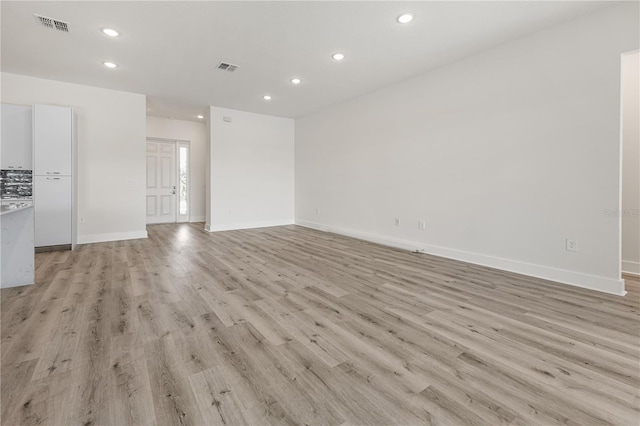 unfurnished living room with light wood-type flooring