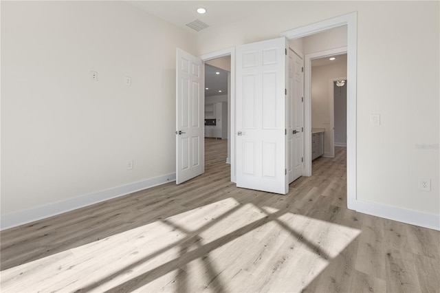 unfurnished bedroom featuring light wood-type flooring