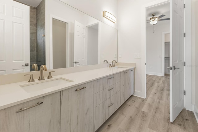 bathroom with ceiling fan, vanity, and wood-type flooring