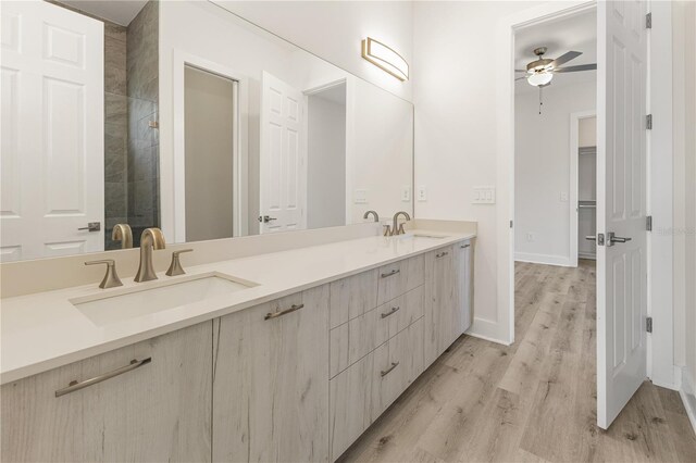 14681 Keystone Blvd, Port Charlotte, FL 33981 - bathroom featuring double vanity, ceiling fan, wood finished floors, and baseboards