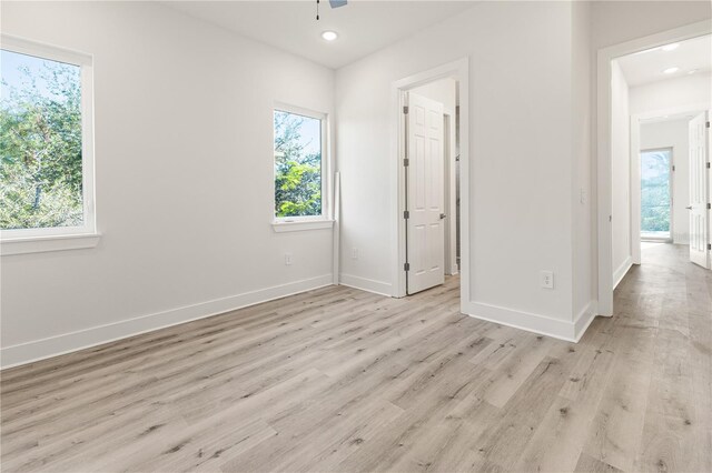 14681 Keystone Blvd, Port Charlotte, FL 33981 - unfurnished bedroom with multiple windows, light wood-style floors, baseboards, and recessed lighting