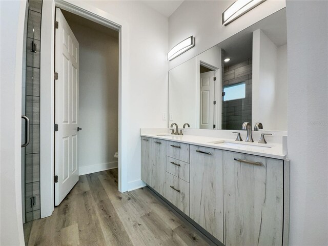 14681 Keystone Blvd, Port Charlotte, FL 33981 - full bathroom with double vanity, a shower stall, wood finished floors, toilet, and baseboards