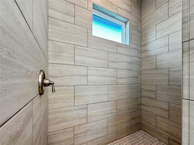 bathroom with a tile shower