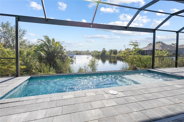 view of pool with glass enclosure and a water view