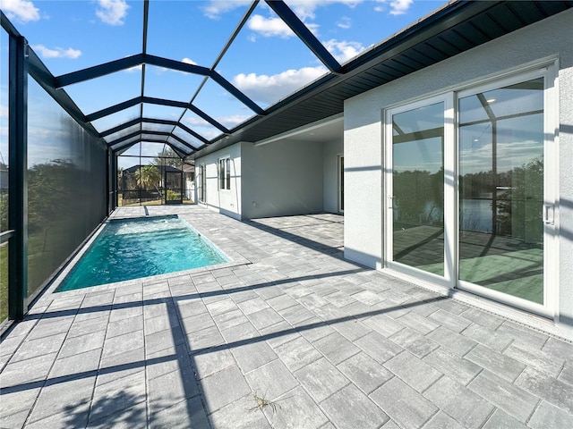 view of pool with a patio and a lanai