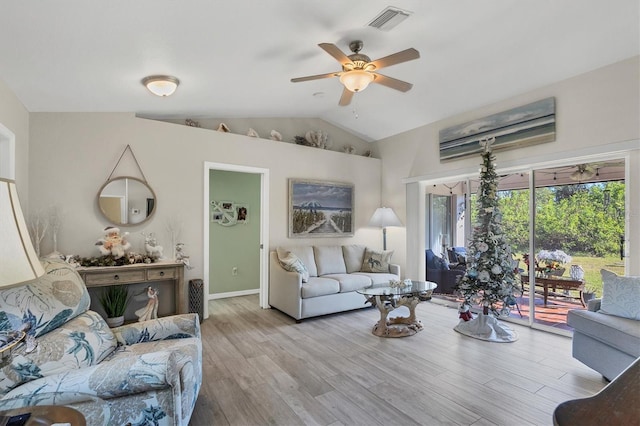 living room with light hardwood / wood-style floors, vaulted ceiling, and ceiling fan