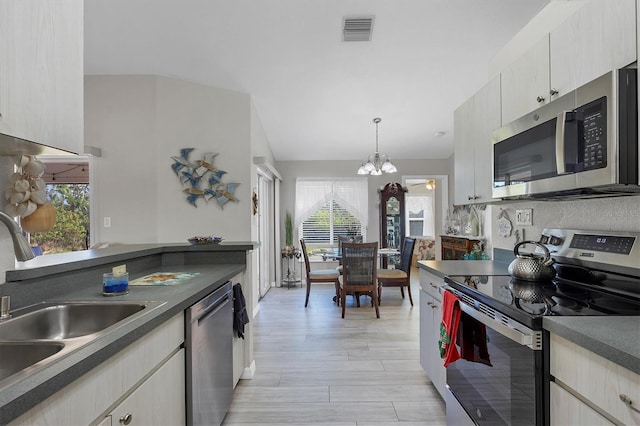 kitchen with a healthy amount of sunlight, light hardwood / wood-style floors, sink, and appliances with stainless steel finishes