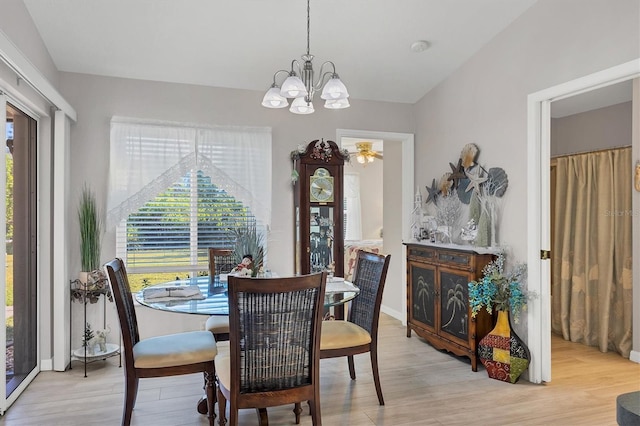 dining area featuring plenty of natural light, an inviting chandelier, and light hardwood / wood-style flooring