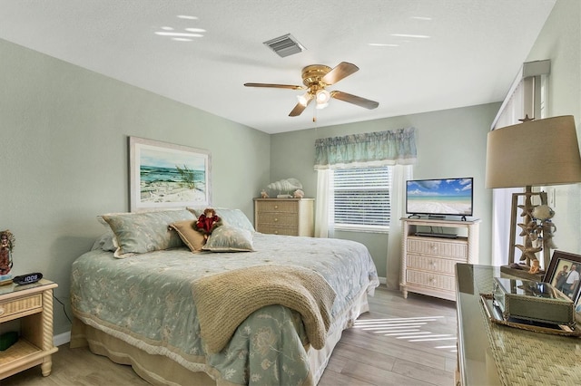 bedroom with wood-type flooring and ceiling fan